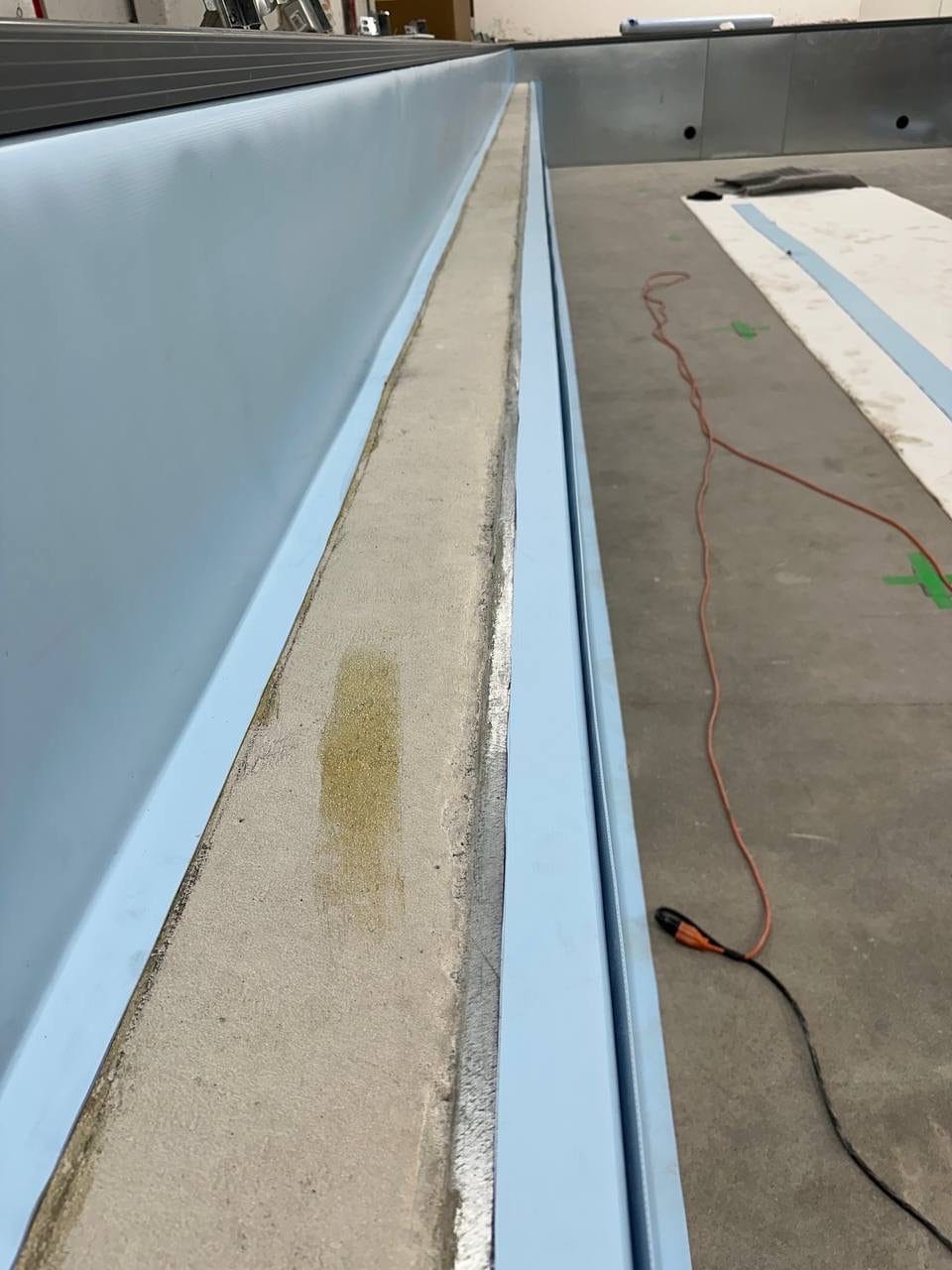 A welded seam of light membrane along the edge of a pool