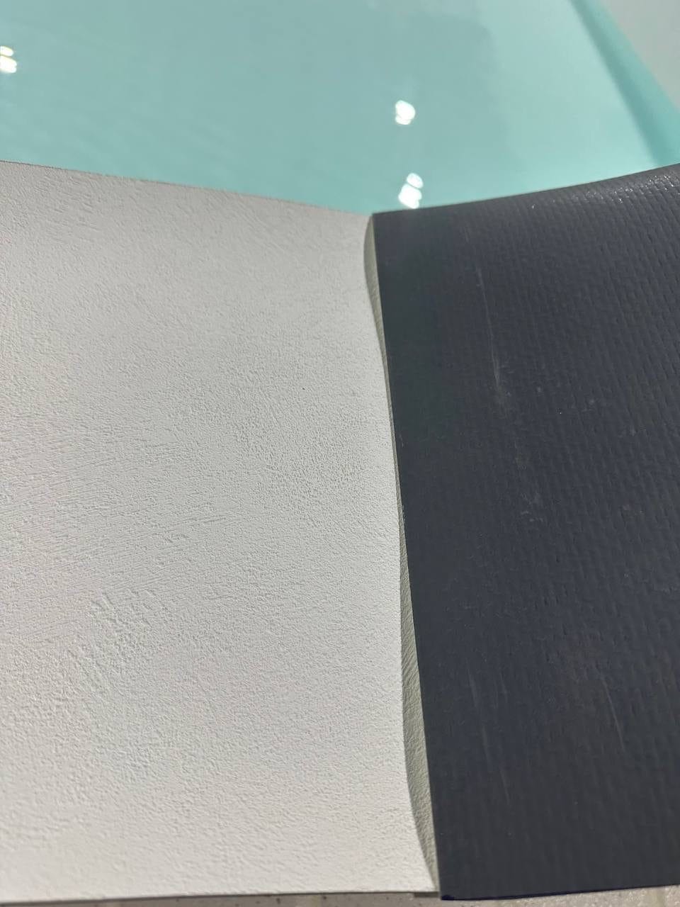 White membrane meeting a dark anti-slip strip