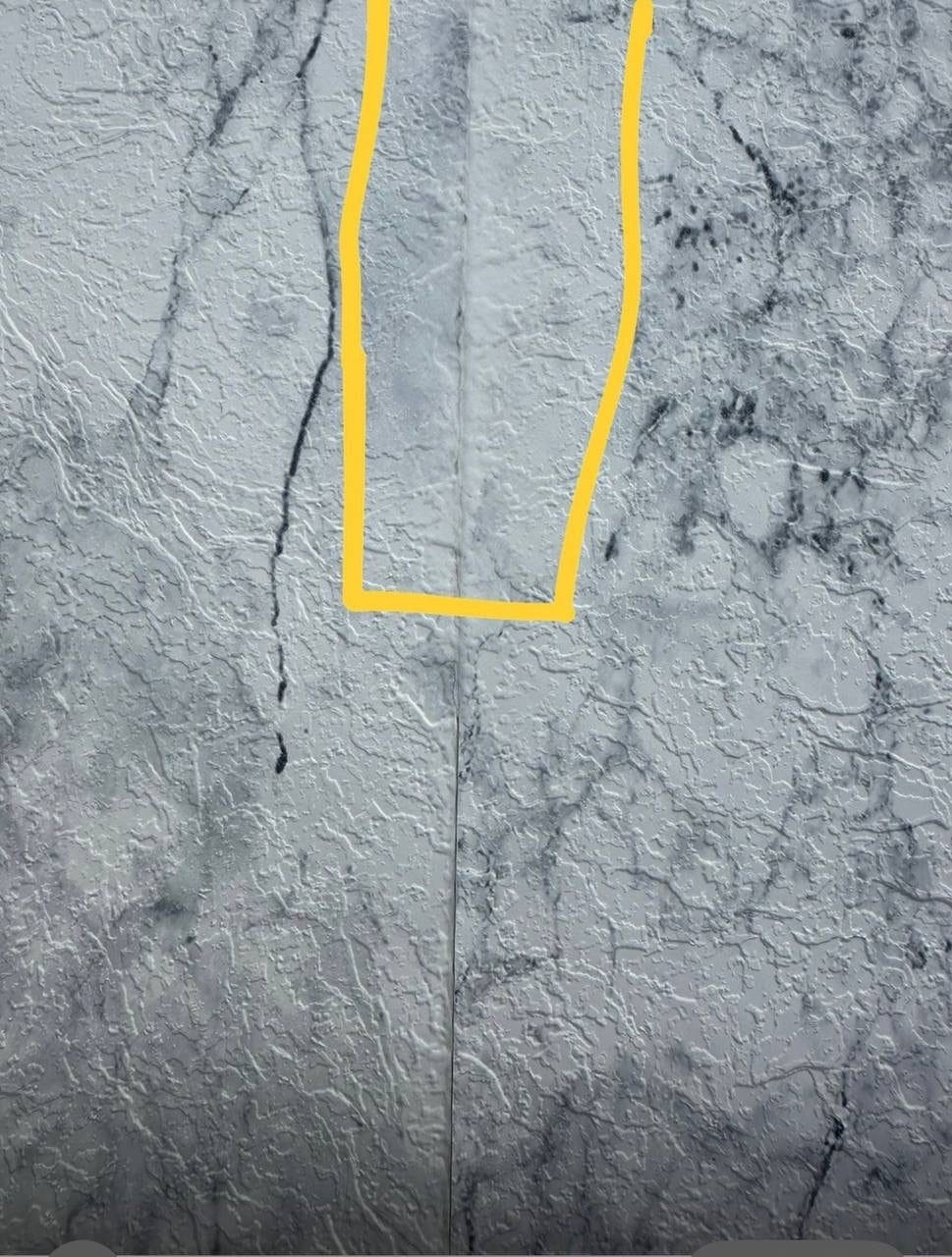 A patch area marked in yellow on marble-pattern membrane