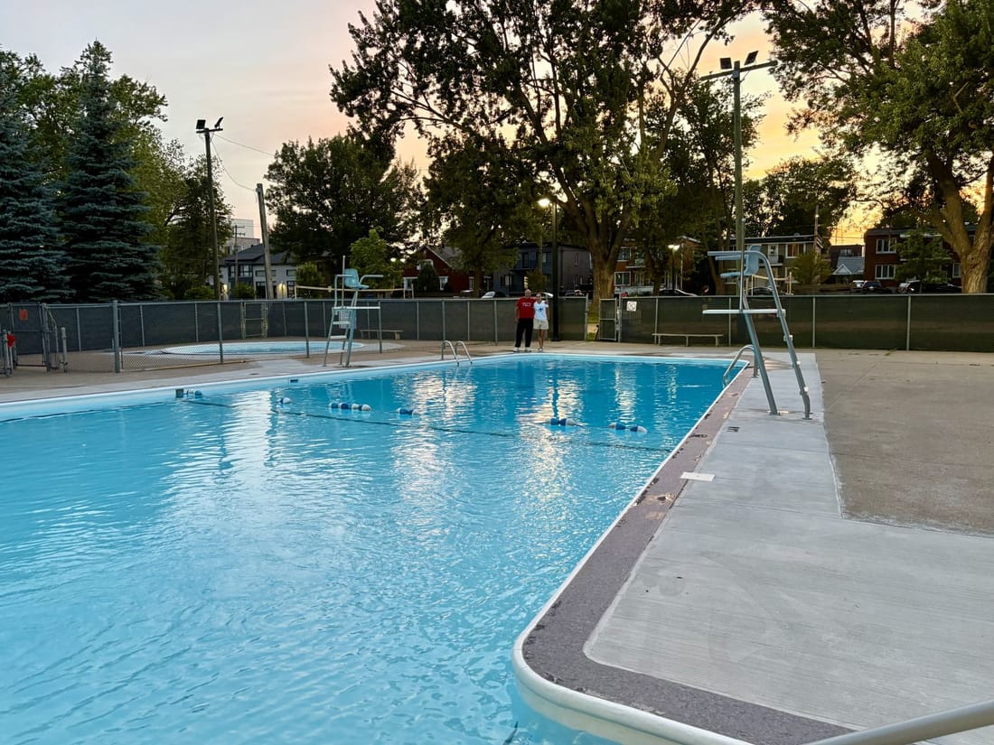 An outdoor public pool lined in light blue PVC membrane